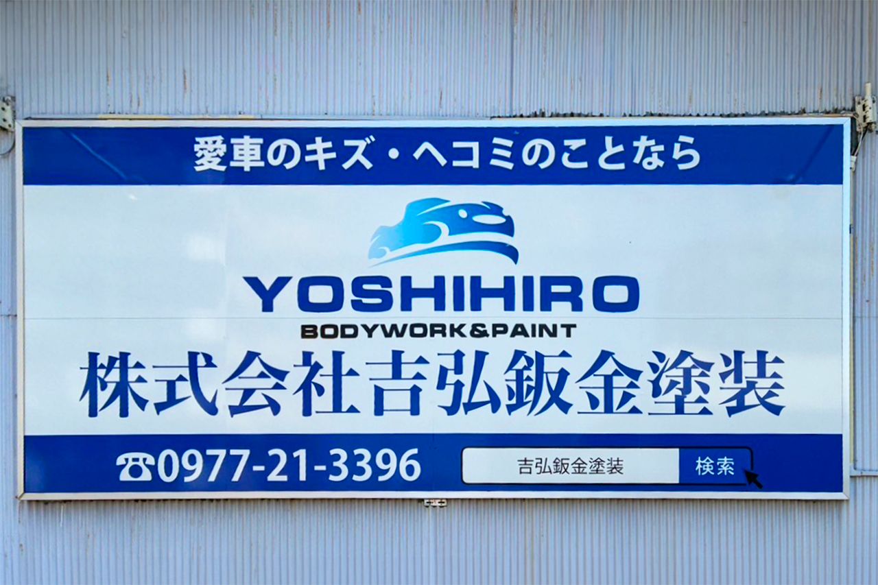 株式会社吉弘鈑金塗装の案内看板。上部に「愛車のキズ・ヘコミのことなら」というキャッチコピー、中央に車のシルエットのロゴと「YOSHIHIRO BODYWORK & PAINT 株式会社 吉弘鈑金塗装」の文字、下部に電話番号と検索窓のイラストが記載されている。